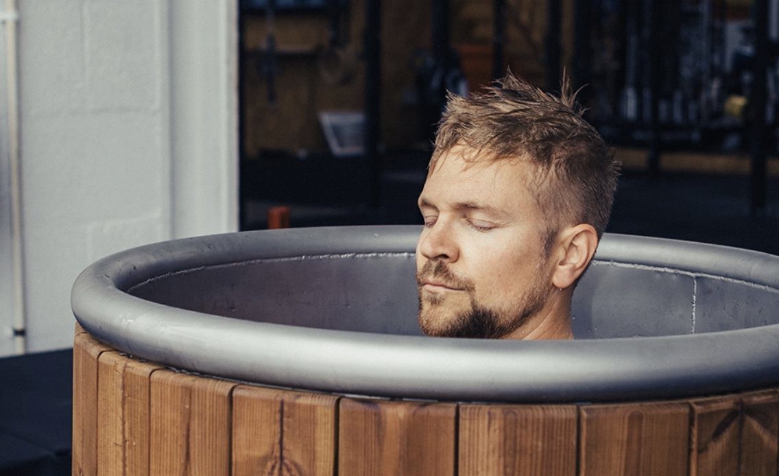 Man relaxing in a cold plunge tub